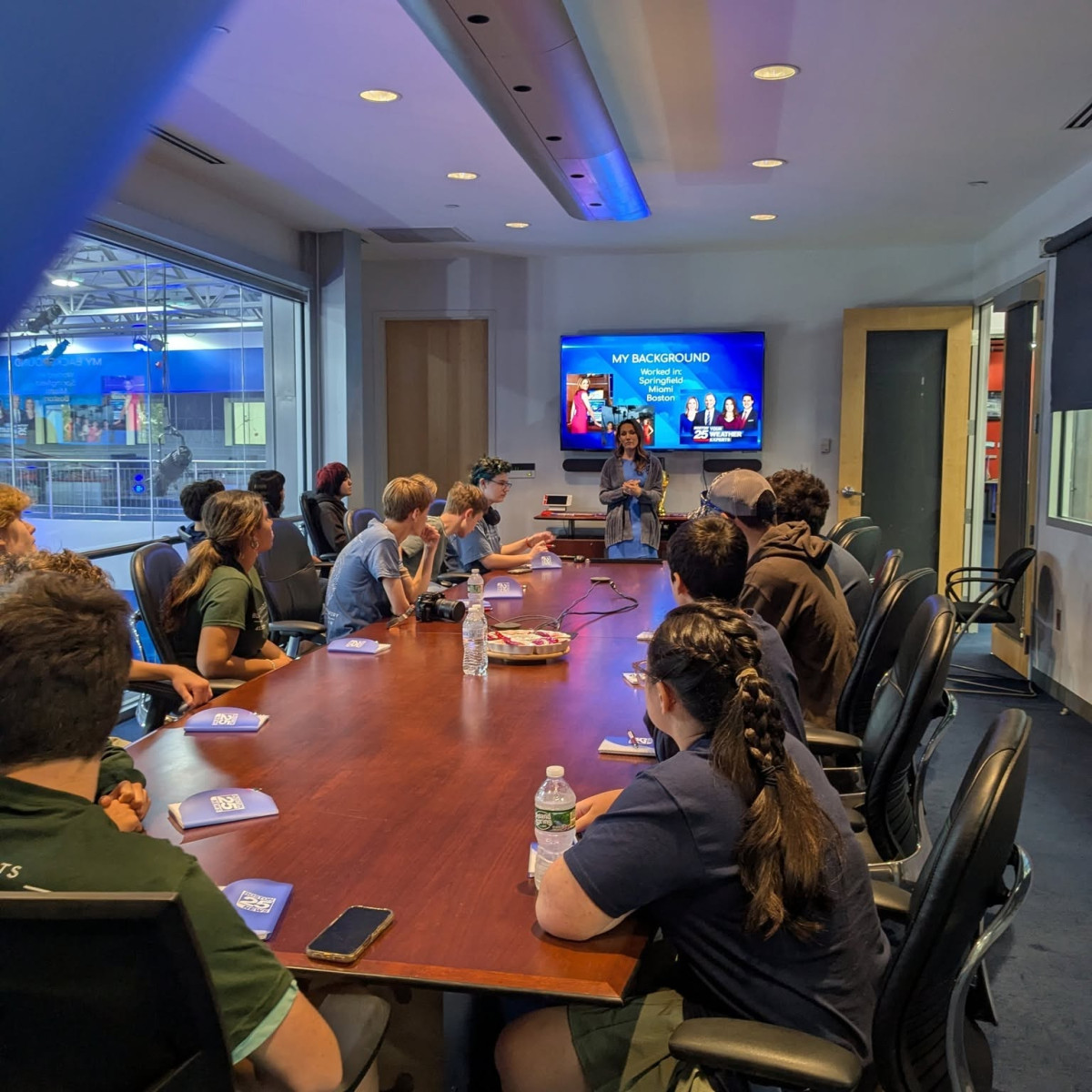 LYMC students in a conference room listening to a Boston 25 News meteorologist discuss her career background