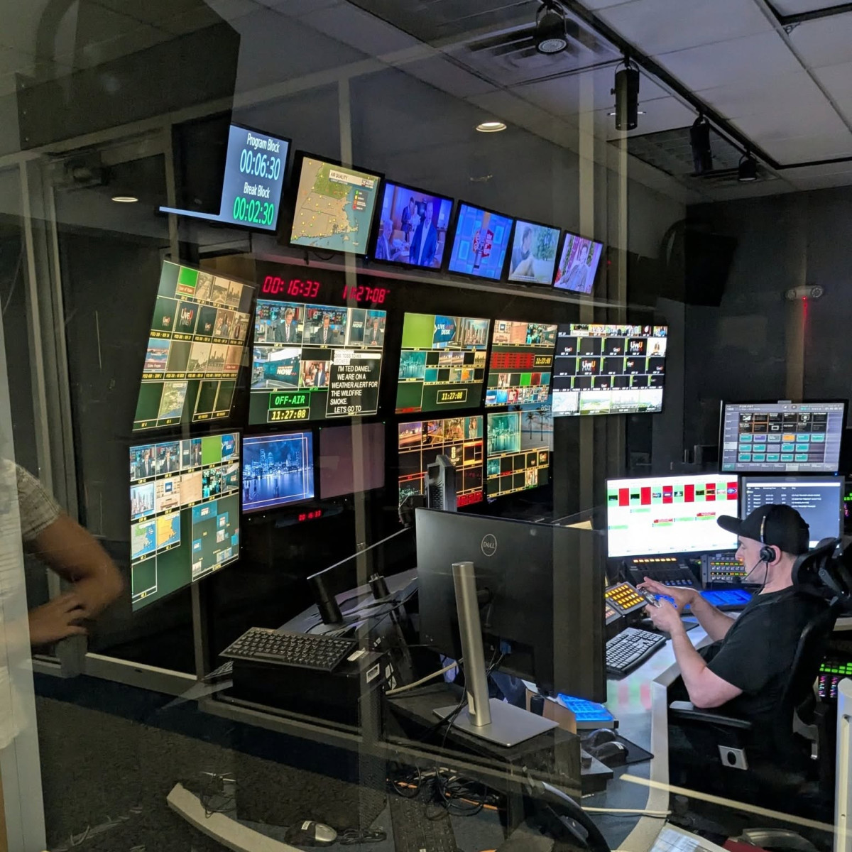 Boston 25 News control room with a wall of broadcast monitors during a live newscast